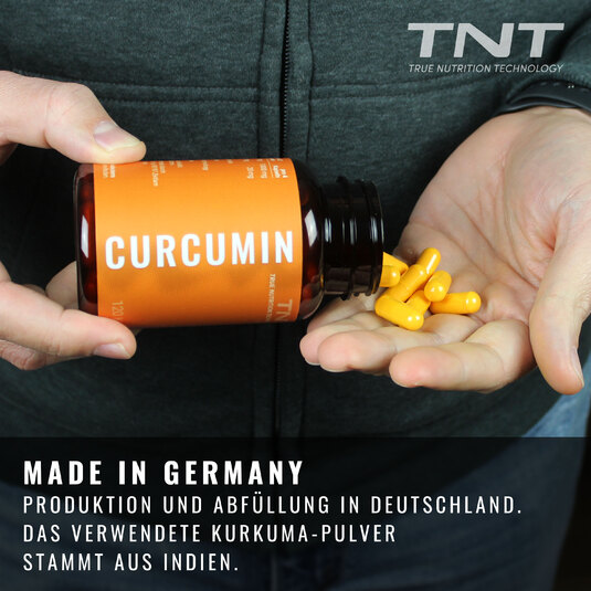 Curcumin-Kapseln werden aus der Dose in die Hand geschttet.